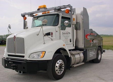 A toter truck, bringing a modular building to a construction site