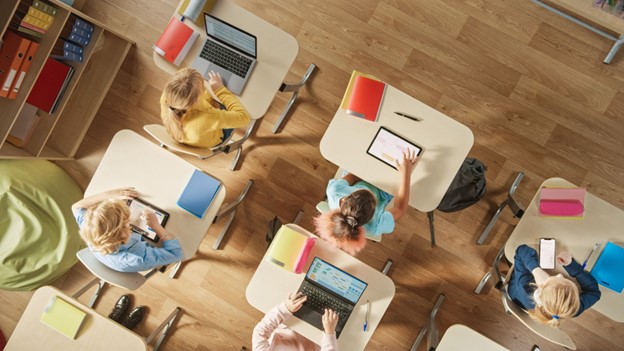 an overhead view of students sitting in classroom desks
