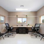 Mock-up of a mobile trailer office workspace with basic furnishings.