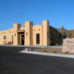 An adobe style building that houses the Oasis Family Health Center.