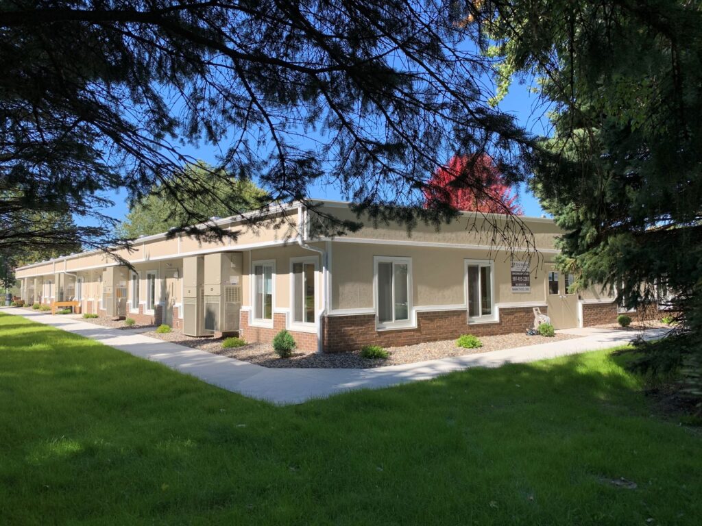 A single-story modular building with a light beige exterior.