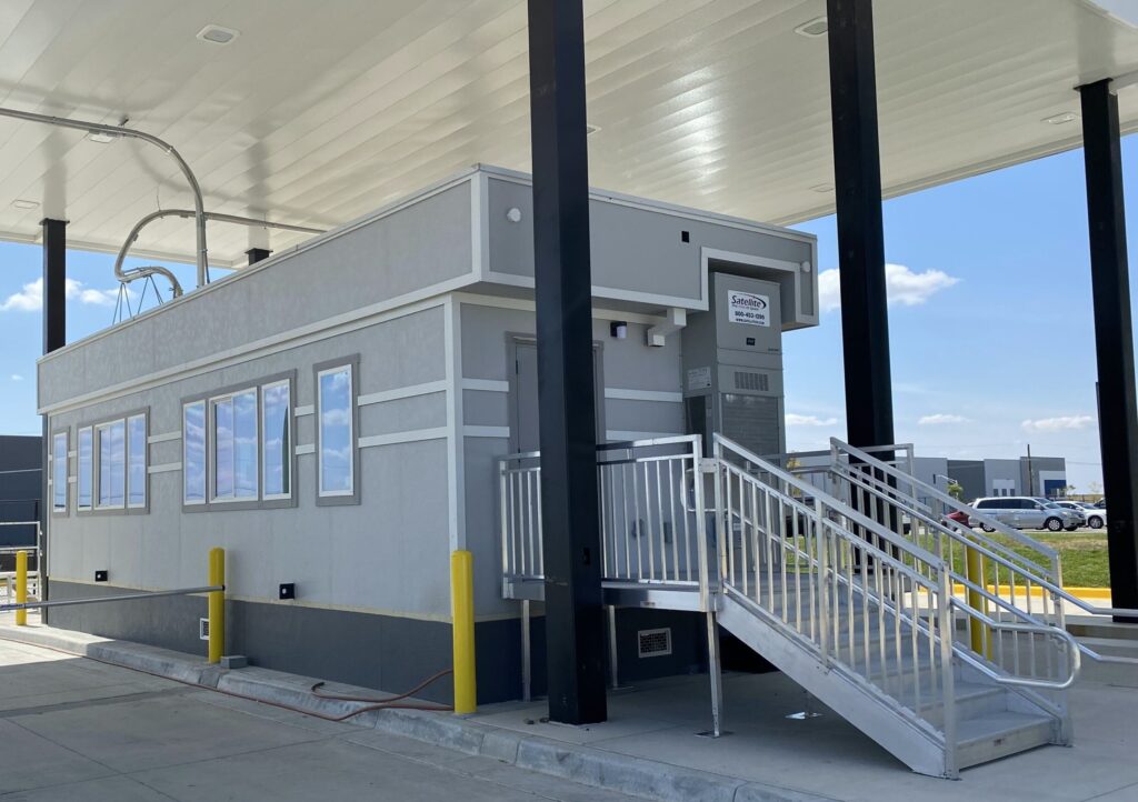 Exterior custom mobile office with steps leading to a door.
