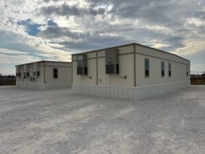 Exterior of a 3-plex modular building and a double wide modular building.
