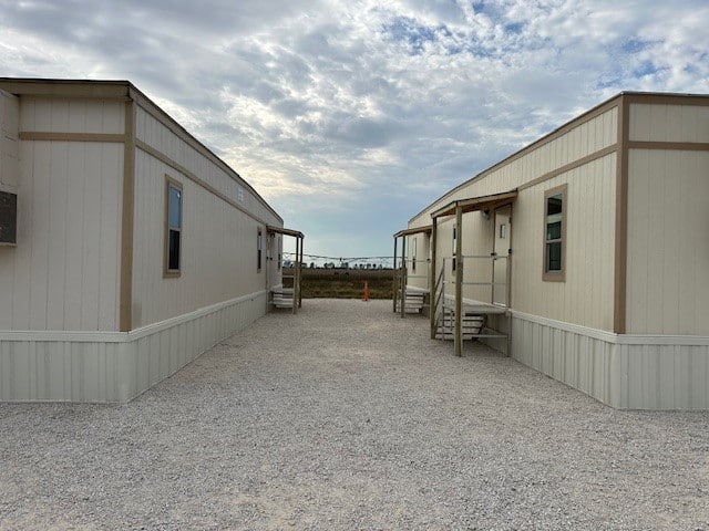 Two mobile offices sitting next to each other with steps leading to exterior doors.