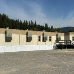 Mobile office on a gravel lot of a construction site.