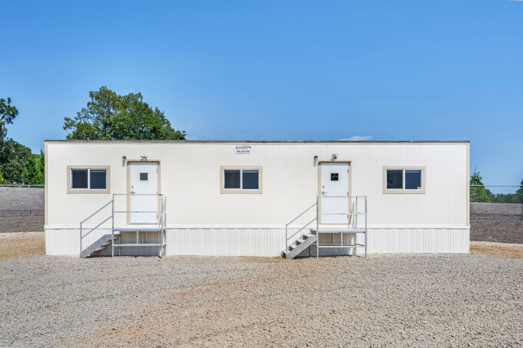 Mobile office with stairs to two doors outside at a jobiste. 